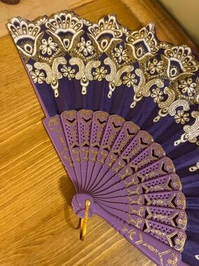 Purple w/ white flowers and golden glitter design Style Hand held fan 15 “